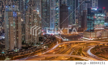 Aerial view on Dubai Marina with big highway intersection night timelapse and skyscrapers around, UAE 88944151