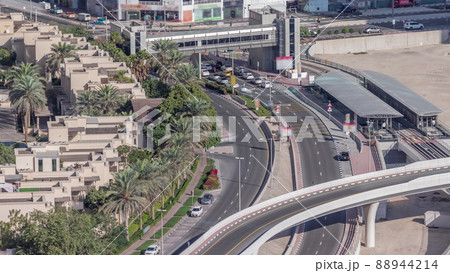 Tram station in Dubai Marina with footbridge aerial timelapse 88944214
