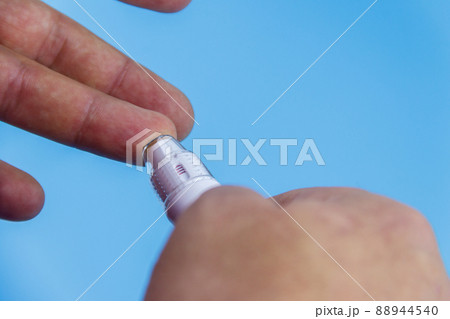 Man taking blood sample with lancet pen. Diabetes concept 88944540