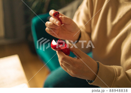 freelancer woman hands with red wireless earphones stay home sit cozy couch living room indoors freelancer woman hands with red wireless earphones stay home sit cozy couch living room indoors 88948838