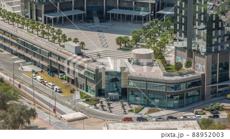 Rooftop garden with palms near entrance to office towers in financial district of Dubai city timelapse 88952003