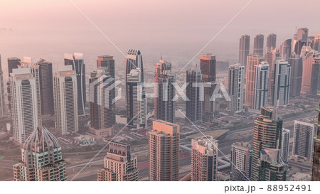 JLT skyscrapers and marina towers near Sheikh Zayed Road aerial timelapse during sunrise. Residential buildings JLT skyscrapers and marina towers near Sheikh Zayed Road aerial timelapse during sunrise. Residential buildings 88952491
