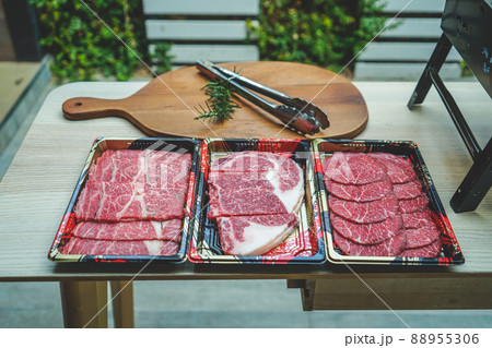 Fresh beef sliced for steak or grilled barbecue with beef tong on cutting board. Fresh beef sliced for steak or grilled barbecue with beef tong on cutting board. 88955306