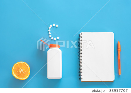 Flat lay, pills on blue background, vitamin c concept. Flat lay, pills on blue background, vitamin c concept. 88957707