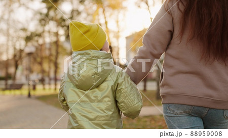 little child kid holding mother hand. closeup hands glare sun. child hand holding mom. child walk with parent park. chidhood dream. weekend park with mom. happy family vacation. walk city park sunset. little child kid holding mother hand. closeup hands glare sun. child hand holding mom. child walk with parent park. chidhood dream. weekend park with mom. happy family vacation. walk city park sunset. 88959008