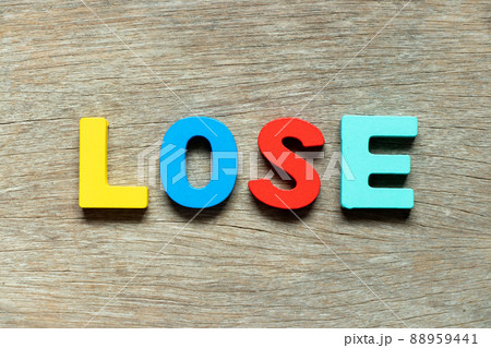 Color alphabet letter in word lose on wood background Color alphabet letter in word lose on wood background 88959441