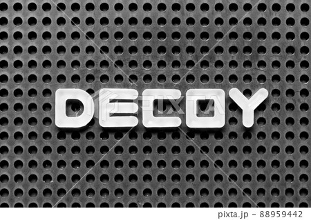 White alphabet letter in word decoy on black pegboard background 88959442
