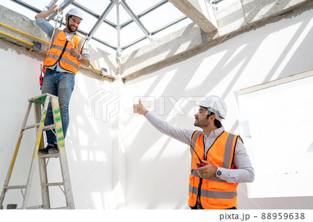 Engineer working on construction building site,Architects discussing project of building outdoors. Engineer working on construction building site,Architects discussing project of building outdoors. 88959638