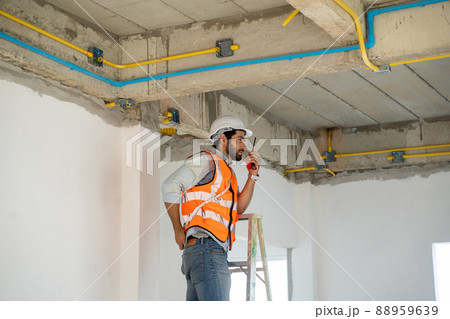 Construction engineering worker talking on radio,Construction engineer use radio communication. 88959639