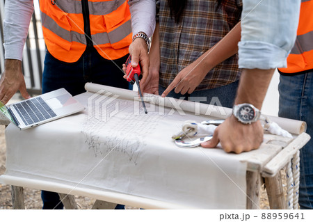 Architect and engineer meeting planning for a new project about detail of building. 88959641