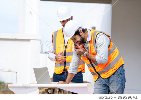 Engineer working on construction building site,Architects discussing project of building outdoors. Engineer working on construction building site,Architects discussing project of building outdoors. 88959643