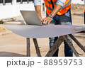 Team engineer and architects are meeting to plan for new project measuring layout. 88959753