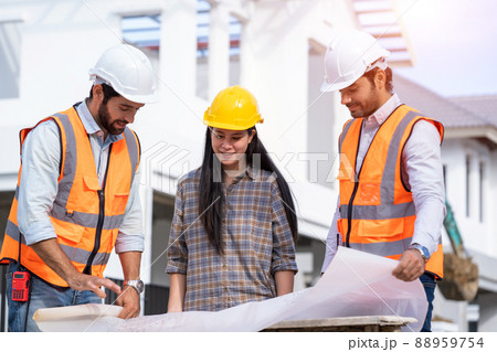Engineer foreman discussion work control to building construction working in site. 88959754