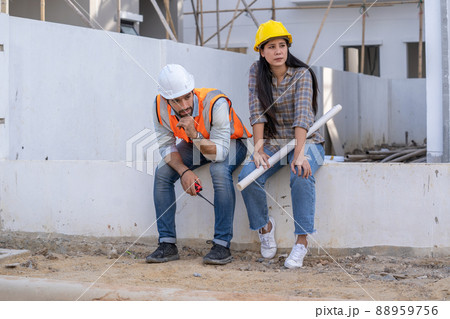 Engineer and architect are stressed at construction site,He is having problems in work. 88959756