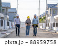 Engineer and architect discussing building plan at construction site. 88959758