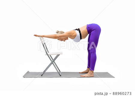 Iyengar yoga. Fit caucasian woman in purple leggings practice