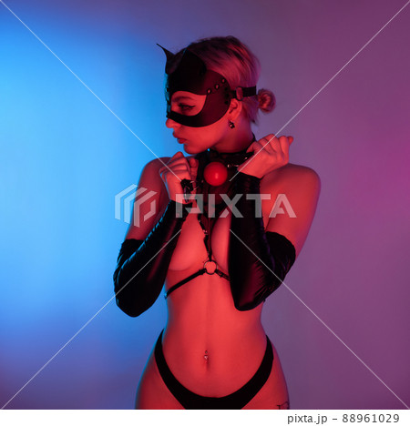 sexy woman in a leather cat mask with a gag for bdsm sex toys sexy woman in a leather cat mask with a gag for bdsm sex toys 88961029