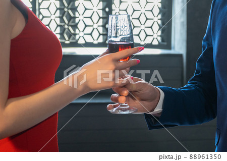 guy's hand gives glass of wine to girl guy's hand gives glass of wine to girl 88961350