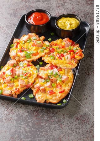 Fritters with ham, corn, peppers and green onions close-up on a plate. vertical Fritters with ham, corn, peppers and green onions close-up on a plate. vertical 88961738