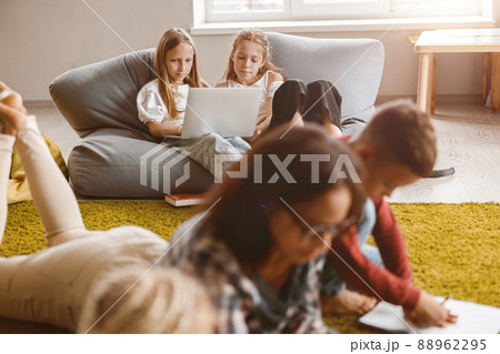 Children using laptop while sitting in classroom Children using laptop while sitting in classroom 88962295