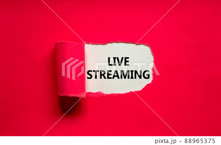 Live streaming symbol. Concept words Live streaming appearing behind torn pink paper. Beautiful pink background. Business, live streaming concept, copy space. Live streaming symbol. Concept words Live streaming appearing behind torn pink paper. Beautiful pink background. Business, live streaming concept, copy space. 88965375