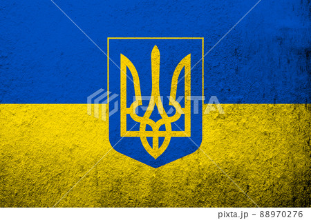 Ukrainian national flag with Coat of arms of Ukraine tryzub. Grunge background 88970276