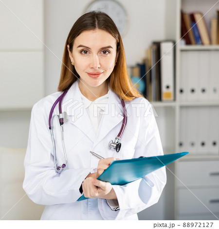 Portrait of female doctor standing in office 88972127