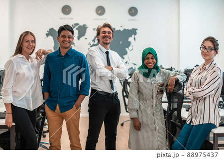Portrait of young excited multiethnics business team of software developers standing and looking at camera at modern startup office 88975437