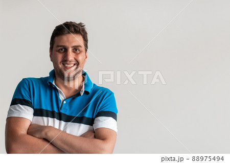 Formal business male portrait. A confident successful casual businessman or manager stands in front of a white background, arms crossed, looking directly at the camera and smiling friendly. High Formal business male portrait. A confident successful casual businessman or manager stands in front of a white background, arms crossed, looking directly at the camera and smiling friendly. High 88975494