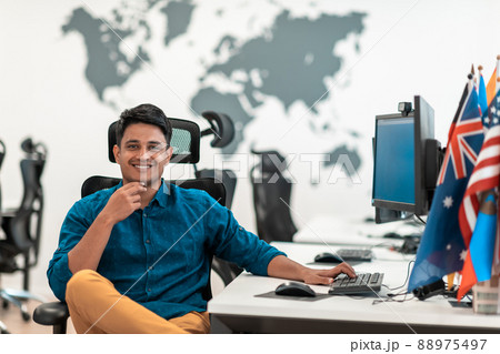 Casual business man working on desktop computer in modern open plan startup office interior. Selective focus  88975497