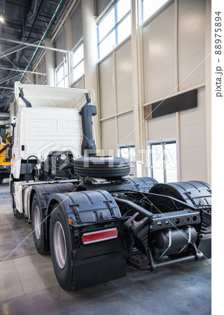 White commercial truck parked in manufacture building. Back view 88975894