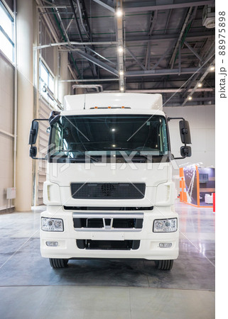 White commercial truck parked in manufacture building 88975898