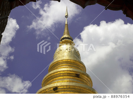 Golden pagoda at Thai temple with blue sky background Golden pagoda at Thai temple with blue sky background 88976354