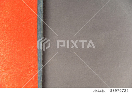 A grayish-red abstract background. Rectangle divided into two multicolored zones. 88976722