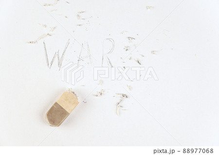Half-erased with an eraser is the word WAR. Handwritten word on white paper. 88977068
