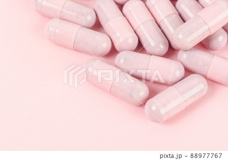 Pink capsule pills on pink background Pink capsule pills on pink background 88977767