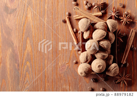 Chocolate truffles on a wooden table. 88979182