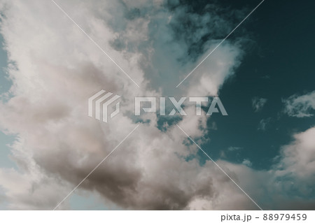 Blue sky with puffy clouds for background. Atmospheric phenomena in formation of precipitation. Blue sky with puffy clouds for background. Atmospheric phenomena in formation of precipitation. 88979459