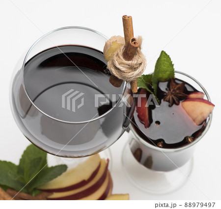 Glass of red wine on white. Fresh and mulled wine Glass of red wine on white. Fresh and mulled wine 88979497