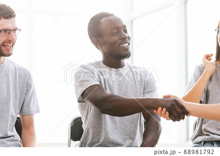 young people greeting each other with a handshake 88981792