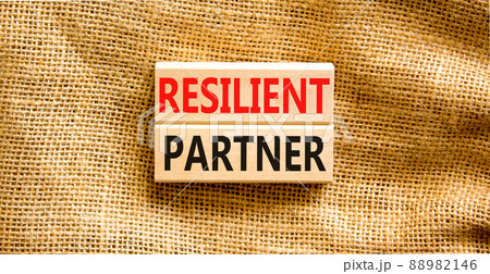 Resilient partner symbol. Concept words Resilient partner on wooden blocks on a beautiful canvas table canvas background. Business resilience resilient partner concept, copy space. Resilient partner symbol. Concept words Resilient partner on wooden blocks on a beautiful canvas table canvas background. Business resilience resilient partner concept, copy space. 88982146