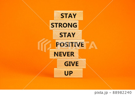 Never give up symbol. Wooden blocks with concept words Stay strong stay positive never give up. Beautiful orange background. Copy space. Motivational business never give up concept. Never give up symbol. Wooden blocks with concept words Stay strong stay positive never give up. Beautiful orange background. Copy space. Motivational business never give up concept. 88982240