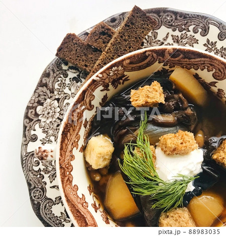 Soup with mushrooms with sour cream and dill in a german brand dish with ornaments. Vegetarian diet dish, organic food 88983035