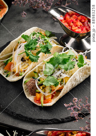Tacos filled with beef meat and vegetables 88983258