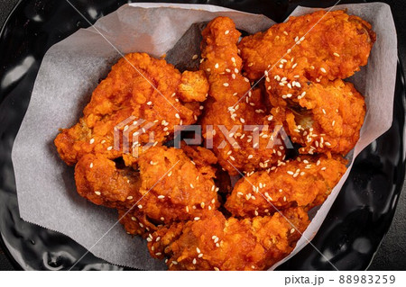 Closeup on crispy fried chicken wings Closeup on crispy fried chicken wings 88983259
