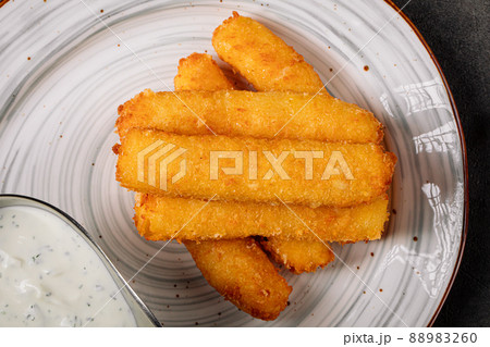 Closeup on fried breaded cheese sticks Closeup on fried breaded cheese sticks 88983260