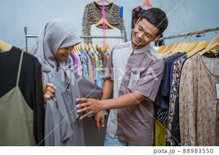 muslim woman shopping some dress for idul fitri with her husband 88983550