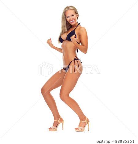Ready to rock the summer. Studio portrait of a sexy young woman cheering in bikini against a white background. 88985251