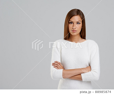 Dont mess with me today. Studio shot of an attractive young woman on a grey background. Dont mess with me today. Studio shot of an attractive young woman on a grey background. 88985874