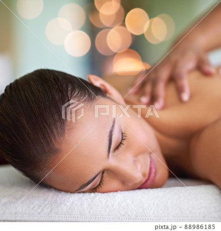 You are worth it. Shot of a young woman enjoying a back massage at a spa. 88986185